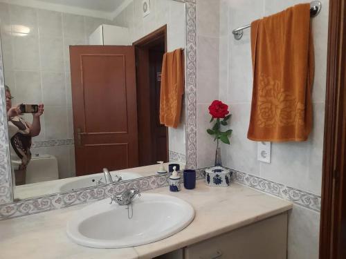 a woman taking a picture of a bathroom sink at Modern apartment in Vilamoura with shared pool in Vilamoura