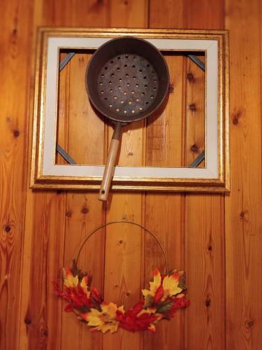 a spatula hanging on a wall with a window at Chalet del Lago Laceno in Villaggio Laceno