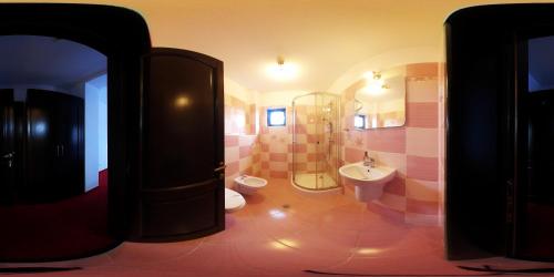 a bathroom with a shower and a toilet and a sink at Pensiunea Soarelui in Fundata