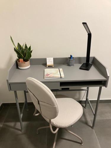 a desk with a chair and a computer on it at IsabellApartments in Canelli