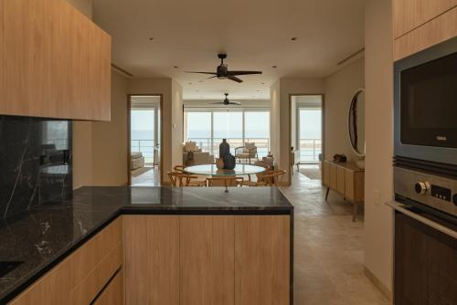 a kitchen with a table and a living room at Sierra Mar in Isla Mujeres