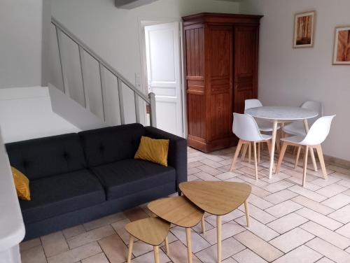 un salon avec un canapé et une table dans l'établissement Longère au calme en ville, à Senonches