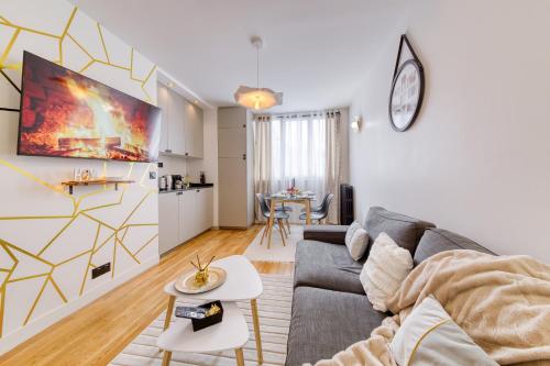 a living room with a couch and a table at L'audace T2 refait à neuf à Vanves in Vanves
