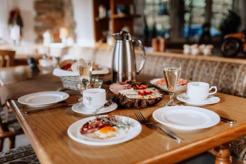 a wooden table with plates of food on it at Waldhotel Weitblick in Fichtach