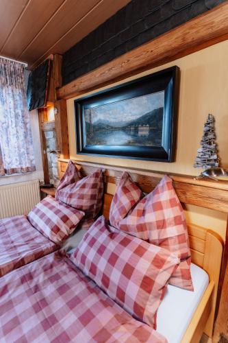 a bedroom with two beds and a tv on the wall at Waldhotel Weitblick in Fichtach
