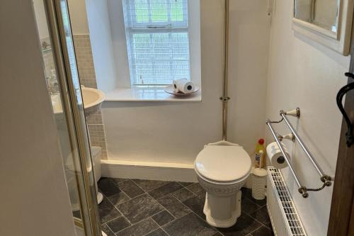 a small bathroom with a toilet and a window at Stunning cottage - 3 Bedrooms & 3 Bathrooms in Bakewell
