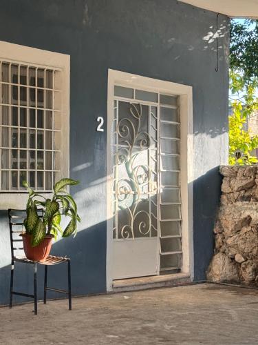 a door with a plant in front of a building at Casa Mango Confort in Mérida