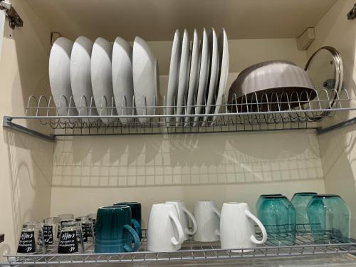 a shelf filled with cups and plates and vases at Dimora Appia in Rome