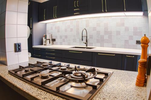 a kitchen with a stove top oven in a kitchen at De Oude Pastorie Macharen in Macharen