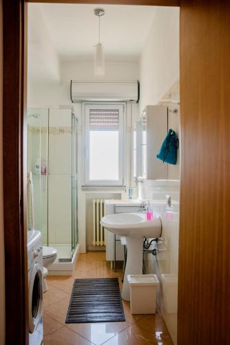 a bathroom with a sink and a shower and a toilet at La Vista Incantata in Comiso