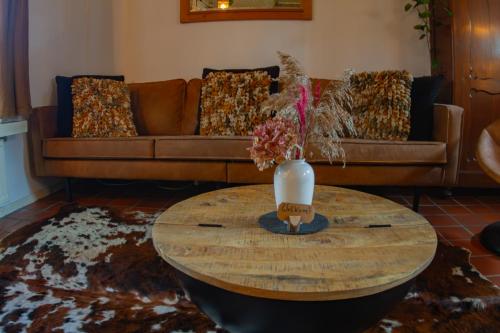 a living room with a couch and a table at De Oude Pastorie Macharen in Macharen