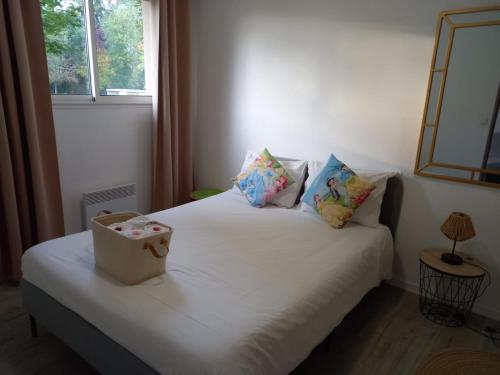 sypialnia z łóżkiem z białą pościelą i poduszkami w obiekcie C016 Appartement 10 MIN de Disneyland Paris w mieście Montévrain