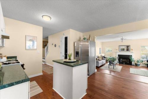 a kitchen and living room with a stainless steel refrigerator at New 4 Bedroom Lithonia Home With Office in Lithonia
