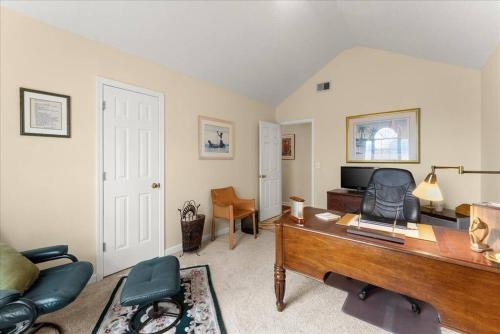 a living room with a desk and a television at New 4 Bedroom Lithonia Home With Office in Lithonia