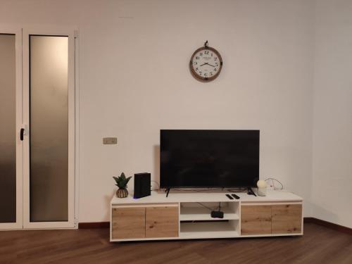 a flat screen tv sitting on top of a wooden entertainment center at Villa São João in Funchal