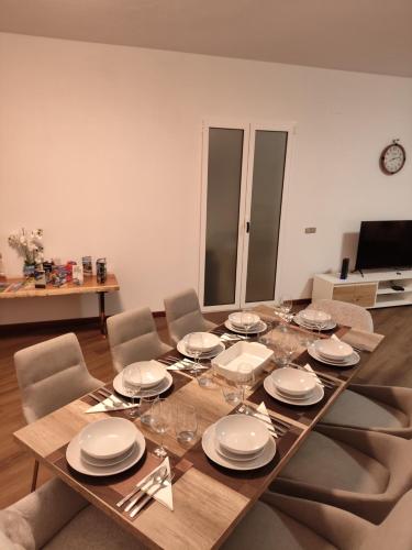 a dining room table with plates and wine glasses at Villa São João in Funchal
