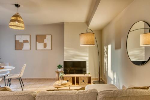 a living room with a couch and a table at L'Harmonie - Beau RDJ 2 pers - Tram T5 in Bron