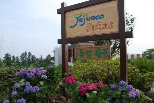 a sign for a flower shop with purple and purple flowers at Jeju Eco Suites in Seogwipo