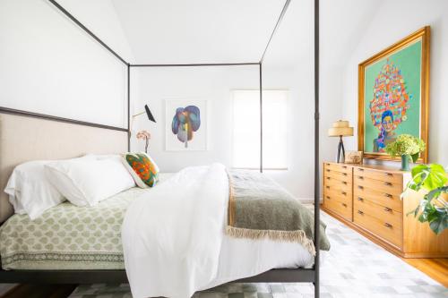 een slaapkamer met een hemelbed en een dressoir bij Ivy Grace - 4 Br, Stylish, Pet-friendly Retreat in Indianapolis