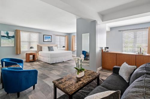 a living room with a bed and a couch at Kasa La Flora and Impala Miami Beach in Miami Beach