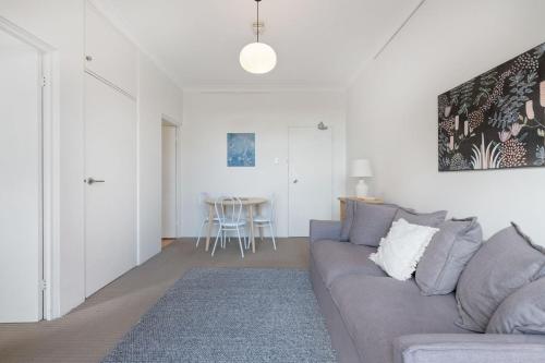 a living room with a couch and a table at Your Stylish Balmain Retreat in Sydney