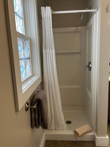 a shower with a shower curtain and a window at Abalonia Inn in Ogunquit