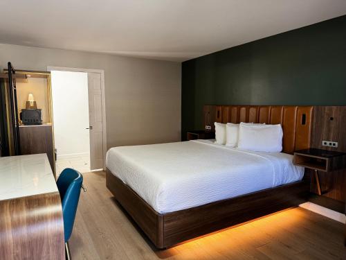 a bedroom with a bed and a green wall at SureStay by Best Western Morgan Hill in Morgan Hill