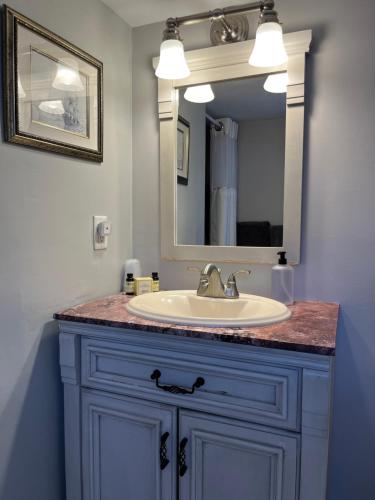 a bathroom with a sink and a mirror at Abalonia Inn in Ogunquit