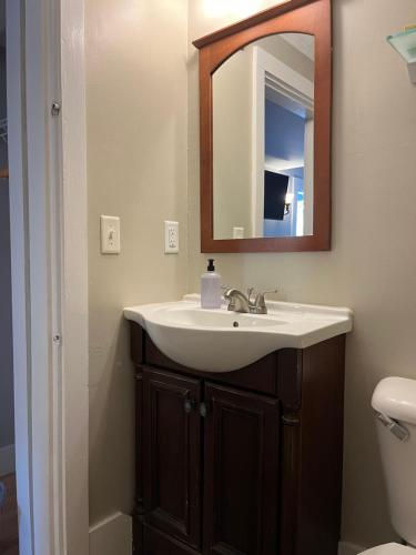 a bathroom with a sink and a mirror at Abalonia Inn in Ogunquit