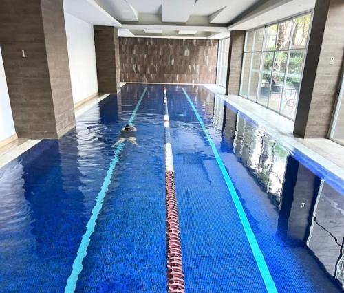 a swimming pool with a person in the water at Grand Tower Del Valle in Mexico City
