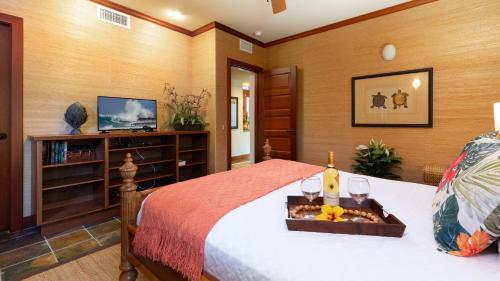 a bedroom with a bed with a tray of food on it at ❤PiH❤ Hale Kanani Hilton Resort PassesFully Detached HomeBeach Gear Bikes in Waikoloa