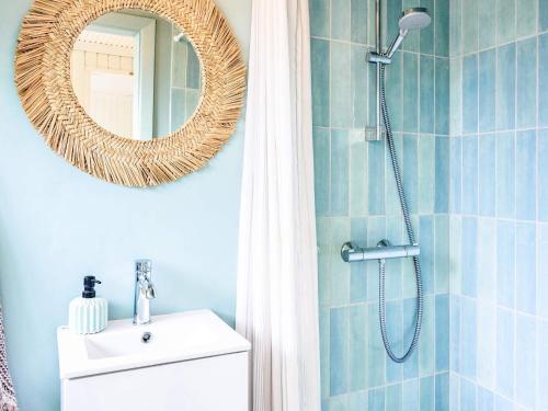 a bathroom with a shower with a sink and a mirror at 6 person holiday home in Faaborg-By Traum in Fåborg