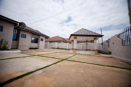 a house with a driveway in front of it at Luxury House in Trede Kumasi in Kumasi