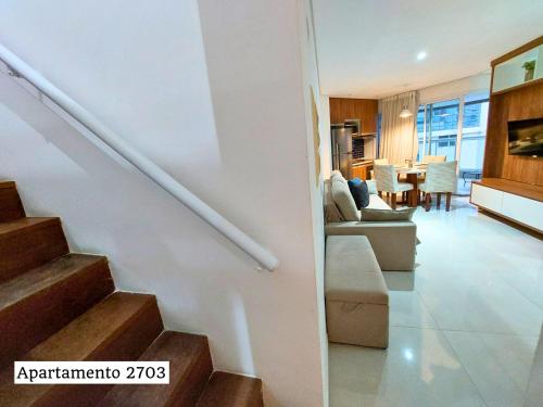 a living room and kitchen with a staircase in a house at Book Santos - Estanconfor Cobertura com Jacuzzi e Vista Mar in Santos