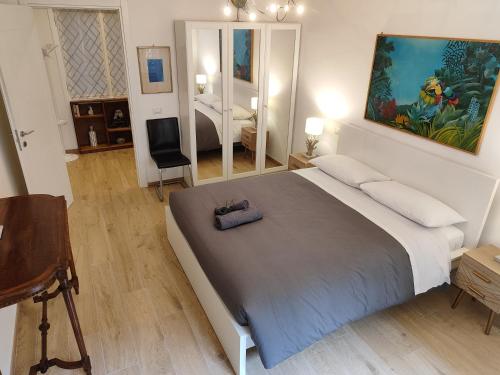 a bedroom with a large bed and a mirror at A&B Vatican Domus in Rome