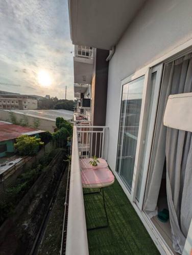 a balcony with a pink bench on the side of a building at Perfect Budget Stay Near Airport in Pusok