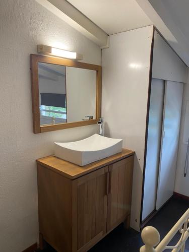 a bathroom with a white sink and a mirror at Charmant Studio Vue Mer Village Soleil in Le Gosier