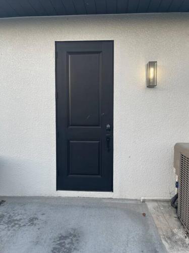 a black door on the side of a building at Casa Blanca Studio with Washer Dryer in Lehigh Acres