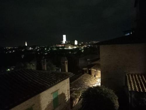 a view of a city at night with lights at The Lovely House in Perugia