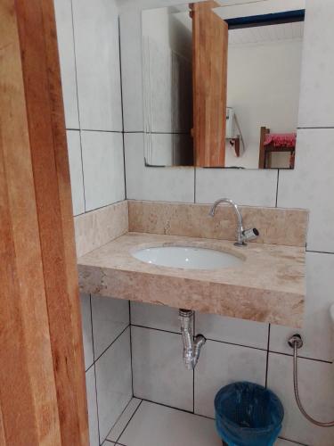 a bathroom with a sink and a mirror at Estância Morro Do Frota in Pirenópolis