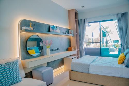a bedroom with a bed and a mirror at The Family at Khaoyai in Wangkata