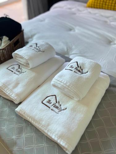 three white towels on top of a bed at The Family at Khaoyai in Wangkata
