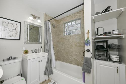 a bathroom with a tub and a sink and a shower at 3 Bed Spacious 1st Floor Apt at Tremont in Cleveland