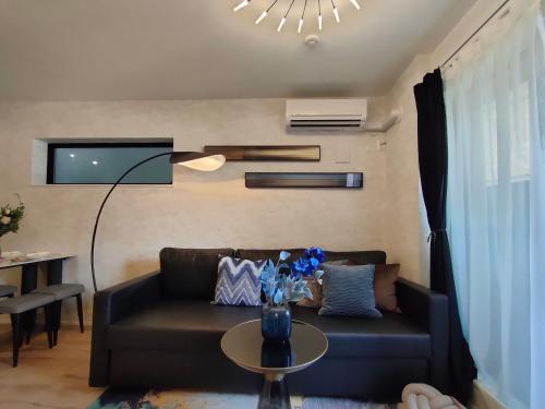 a living room with a couch and a table at 新宿2站 池袋全新独立3层别墅 3室1厅1浴室 最大8人 max 8P 车站7分钟 7mins to ST 银座 新宿 涉谷 池袋 东京直通 in Tokyo