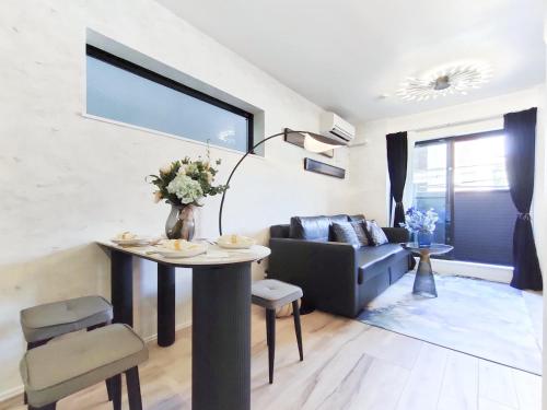 a living room with a table and a couch at 新宿2站 池袋全新独立3层别墅 3室1厅1浴室 最大8人 max 8P 车站7分钟 7mins to ST 银座 新宿 涉谷 池袋 东京直通 in Tokyo