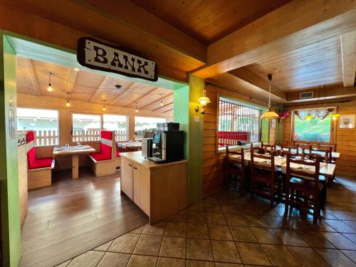 a restaurant with a bar with tables and chairs at La Locanda in Livigno