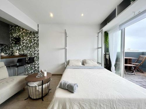 a bedroom with a large bed and a table at Skyline Coruña in A Coruña