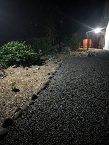 a garden at night with a rock pathway at Enjoy Studio in Pointe-Noire