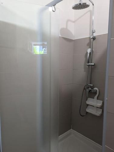 a bathroom with a shower with a glass door at Enjoy Studio in Pointe-Noire