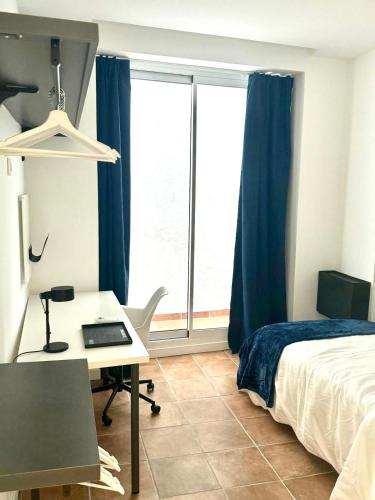 a bedroom with a bed and a desk and a window at Guest House Espinardo Murcia Casa Universitaria in Murcia